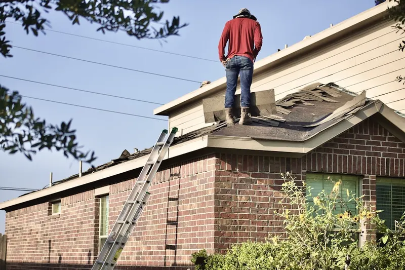 Professional roofer working on a residential roof in Trexler